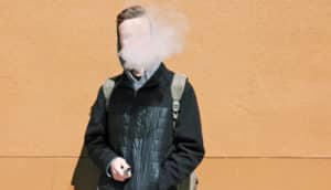person in coat, backpack vapes