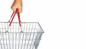 hand holds empty shopping basket. White background