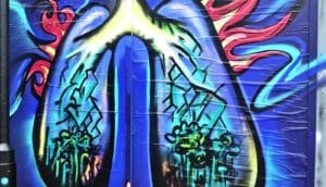 Street art depicting lungs on fire on a brick wall