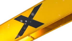 A yellow sign with a black X on it.