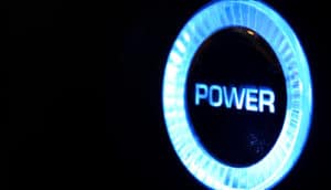 A button glows blue in the dark and has the word "power" on it.