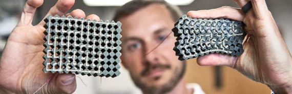 A research holds up an uncompressed circuit and one that's crunched down due to pressure.