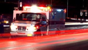 trailing brake lights and ambulance on highway