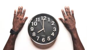hands alongside clock