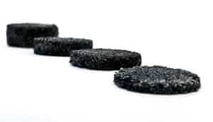 four black spongy discs of increasing thickness