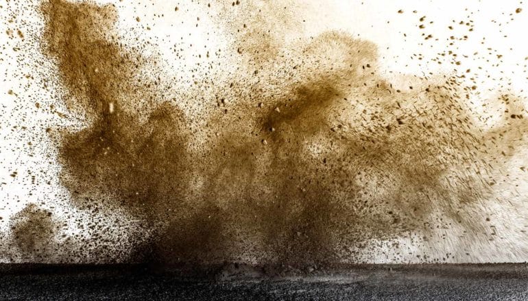 Dust bursting into the air after an impact.