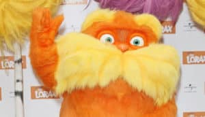 fuzzy orange character with yellow mustache and eyebrows waving
