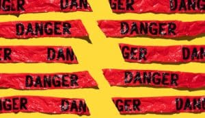 broken red "danger" tape on yellow