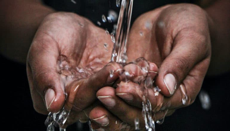 water flows into cupped hands