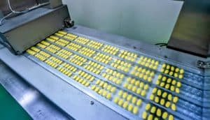 yellow pills on assembly line