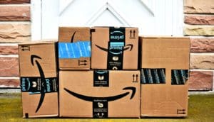 A bunch of Amazon packages on a doorstep.