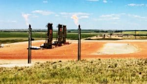 Fire flares from pipes in a natural gas operation.