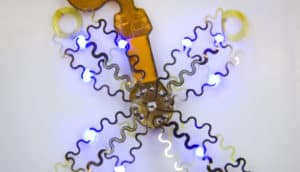 The pacemaker has several tendrils of coiled electronics with bright blue lights on them.