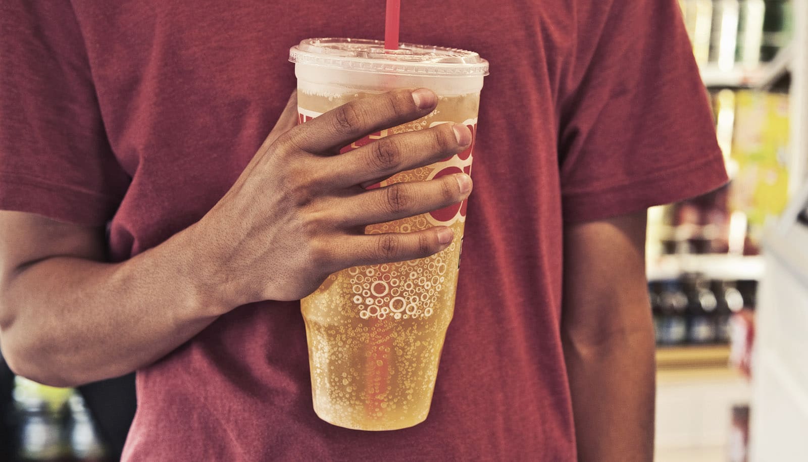 hand holds giant soda