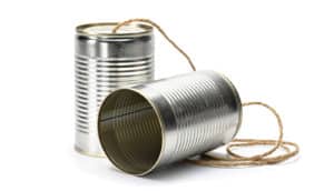 Two cans connected by a string on a white background.