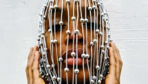 face behind silver beads on string