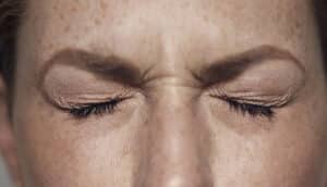 eyes of person wincing