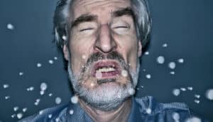 sneezing man