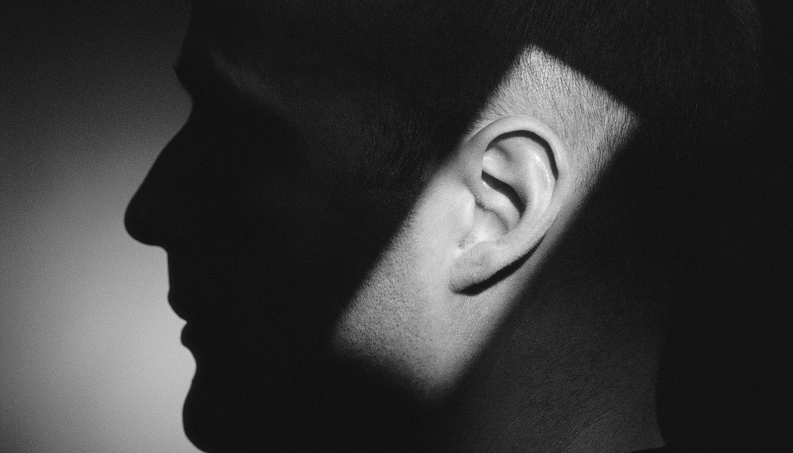 silhuet ansigt i profil med rektangel af lys på øret