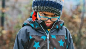 upset child in hat and coat