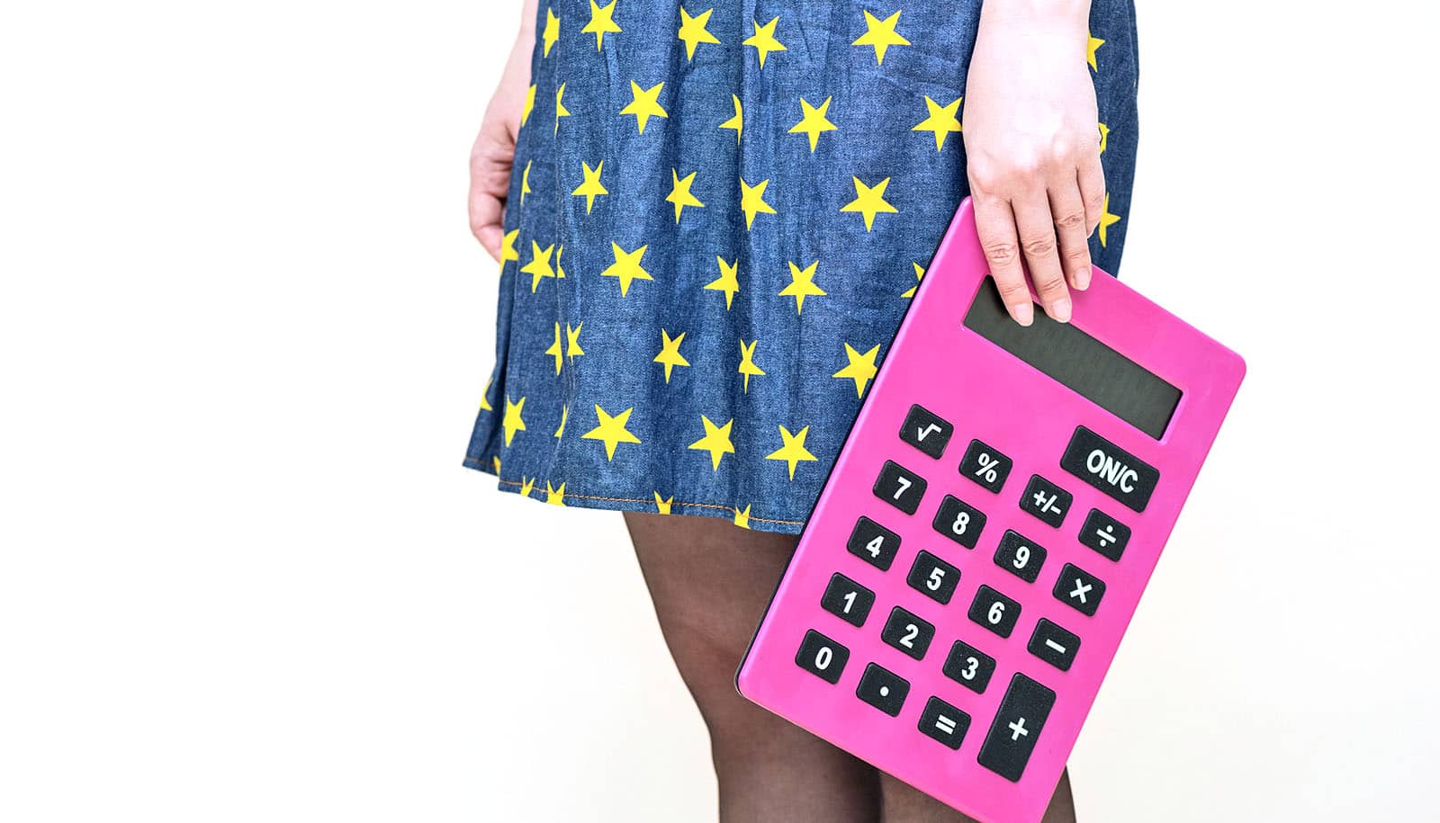hand holds big pink calculator by side of body