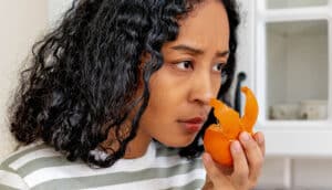 serious person smells orange