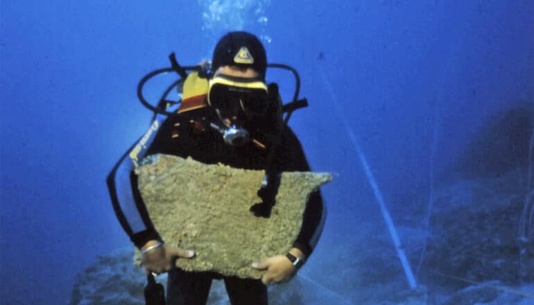 diver holds slab 