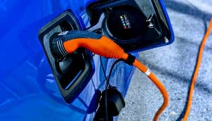 blue EV charging with orange cord