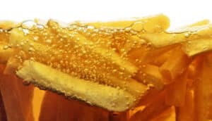 French fries cooking in oil.