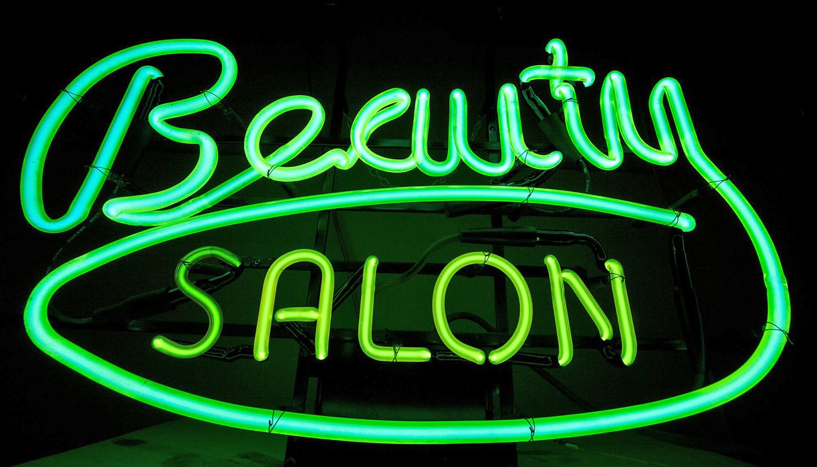 A green neon sign reads "Beauty salon."