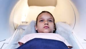 A young girl is about to get a CT scan.