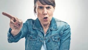 angry person in denim jacket points