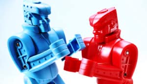 A red and blue toy robot are about to start fighting each other.