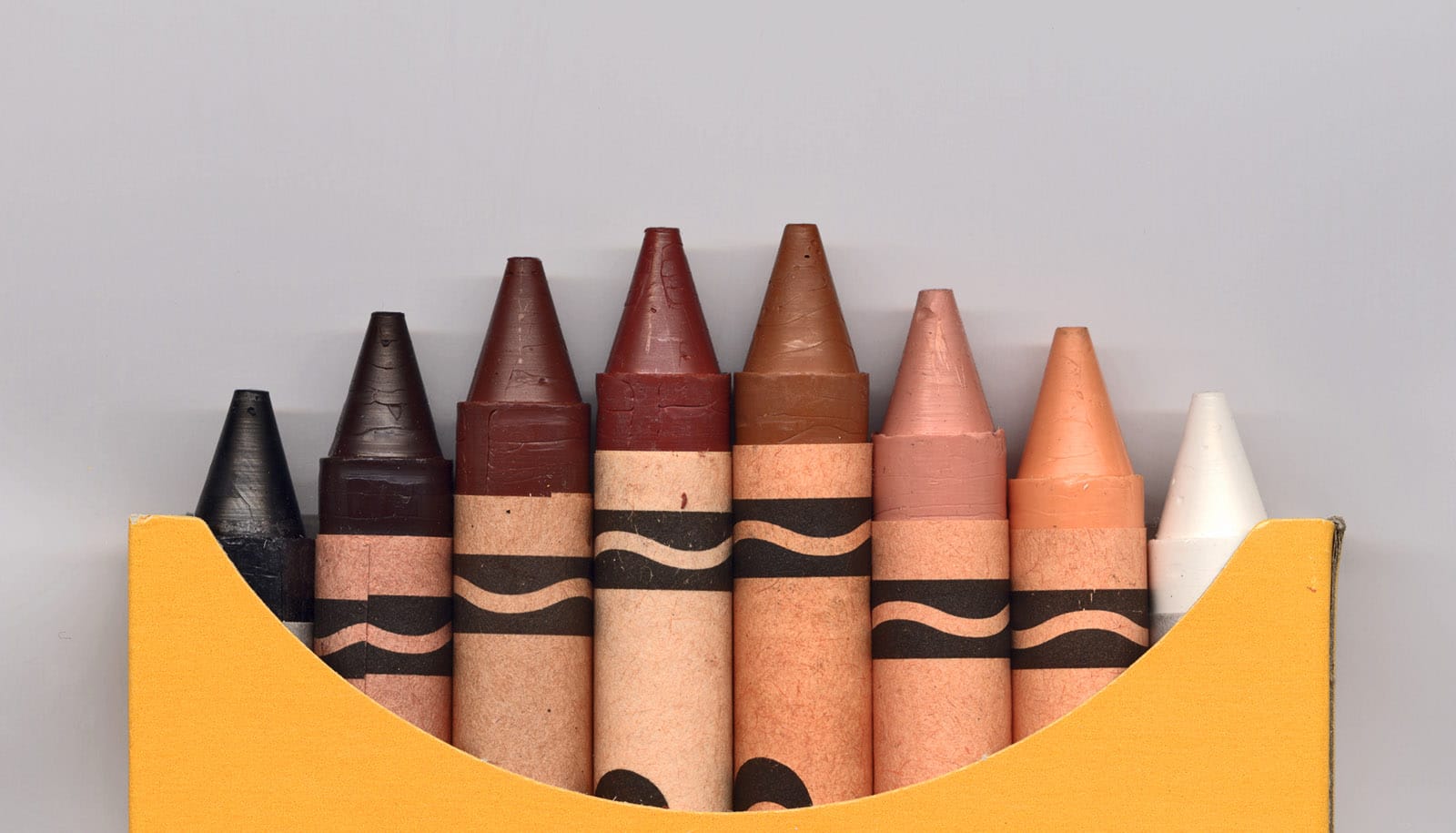 eight crayons in range of skin tones