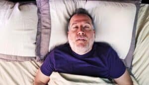 A man sleeps with his mouth open.