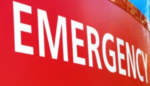 A red hospital sign reads "Emergency" in white.