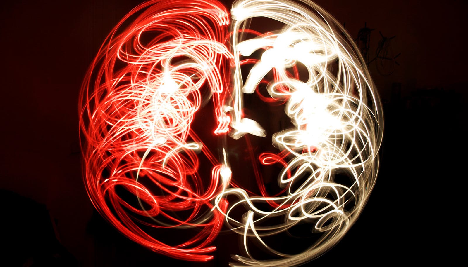 A long-exposure shows light trails making the shape of a brain.
