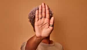 person holds up hand to gesture "no"