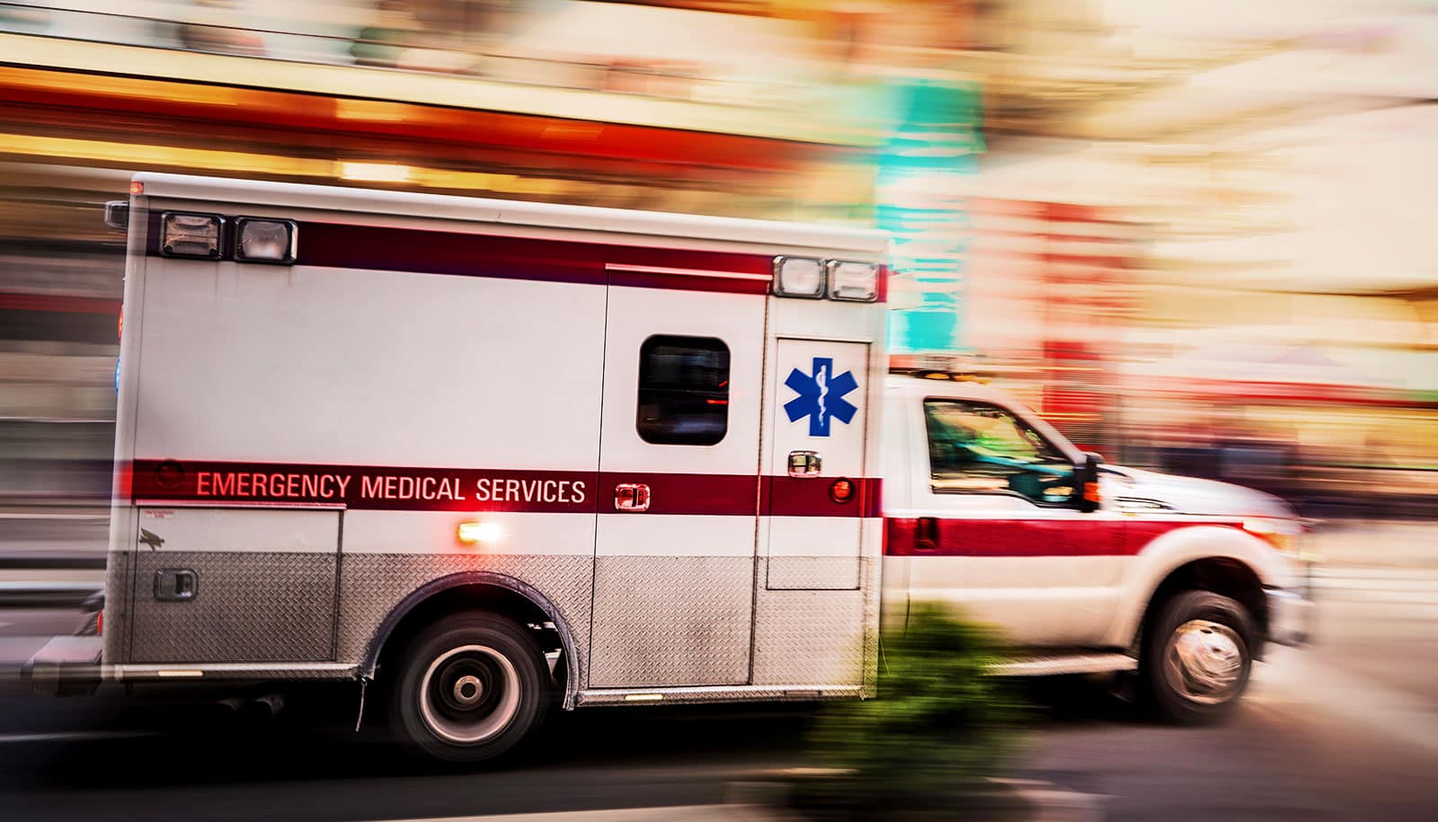 An ambulance speeds through a city.