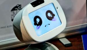 A robot with a screen for a face showing a cartoonish sad expression.