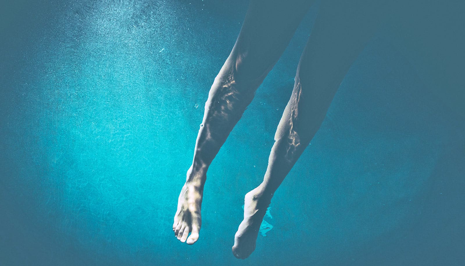 A swimmer's legs underwater.
