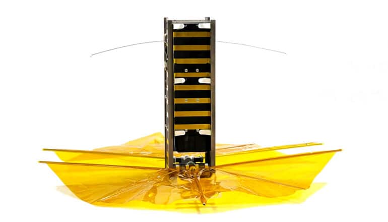 rocket device on white, black tower on top of yellow fabric