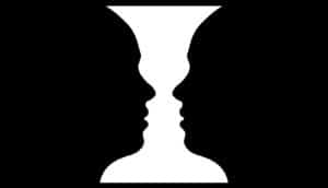 features of two faces in black create vase or candlestick shape between them in white
