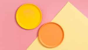 yellow and orange plates on pink and yellow surface