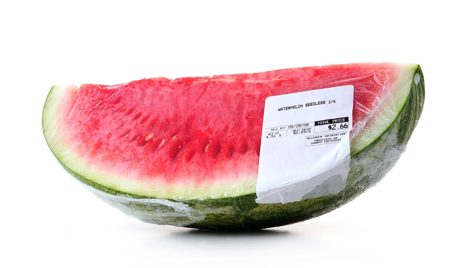 A quarter of watermelon in plastic wrap with a price label on it.