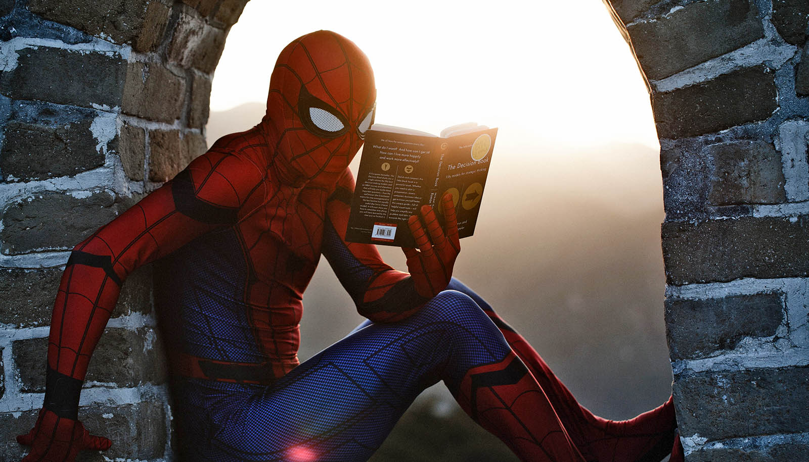 spiderman reads book in stone arch