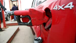 red gas pump nozzle in red 4x4 vehicle