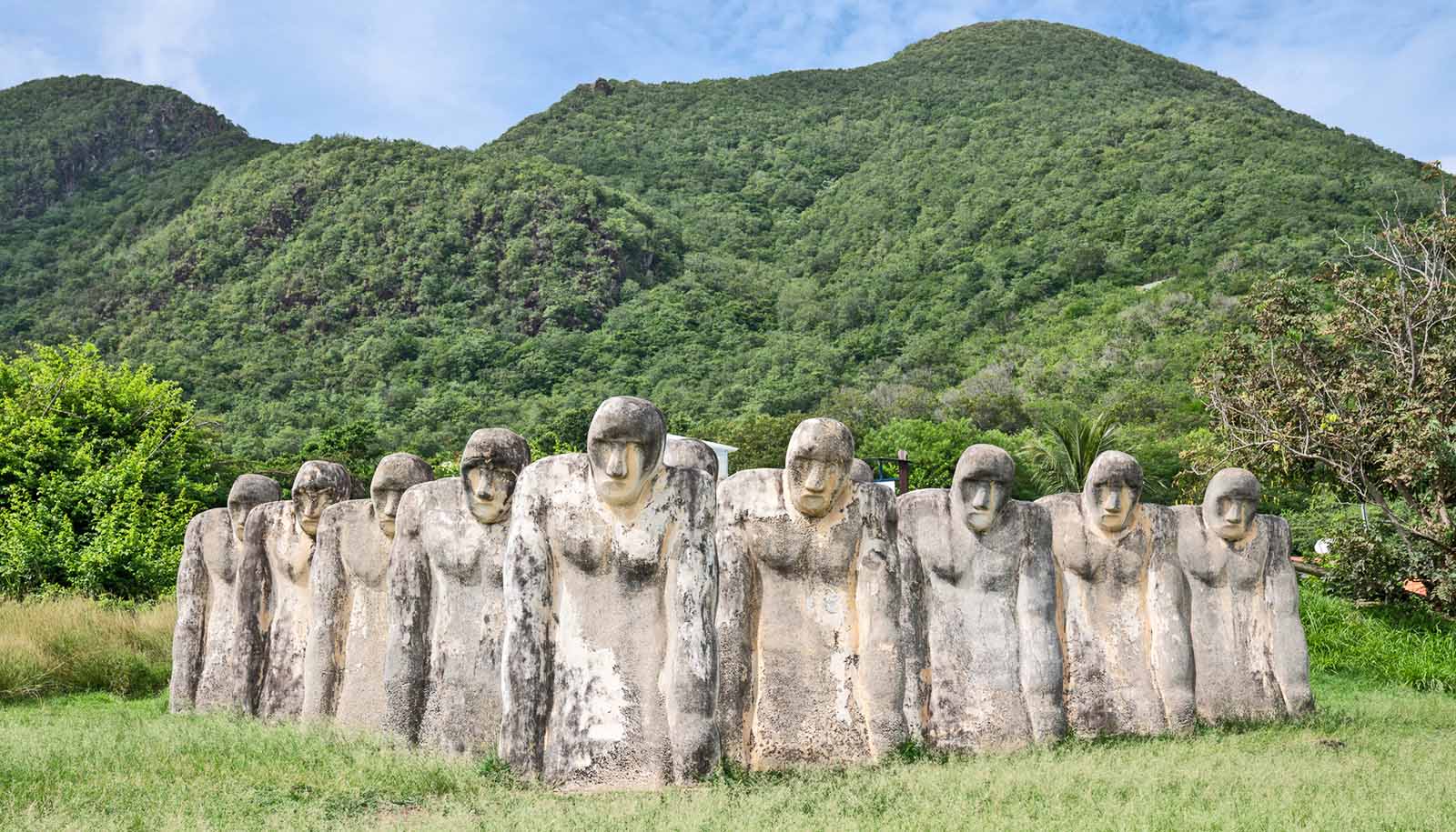 slavery memorial monument in martinique -- stone figures in formation appear to look downward