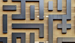 A maze sculpture on a wall.