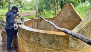 A researcher next to a well.